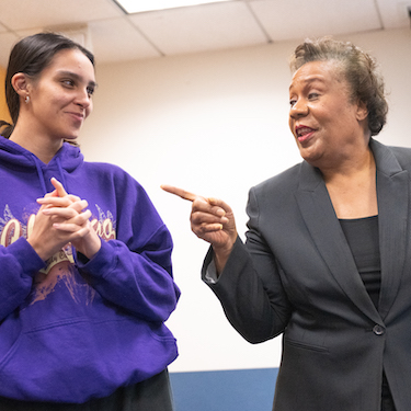 A photo of Jackie Taylor (right) speaking to a person on her left as she leads a workshop at Northeastern Illinois University. 